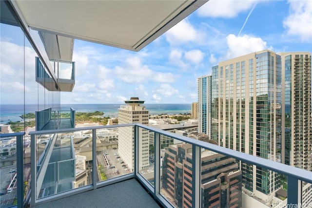 balcony with a water view and a city view