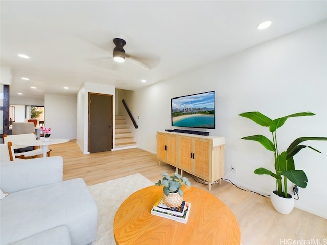 living room with light wood-style flooring, stairway, ceiling fan, and recessed lighting