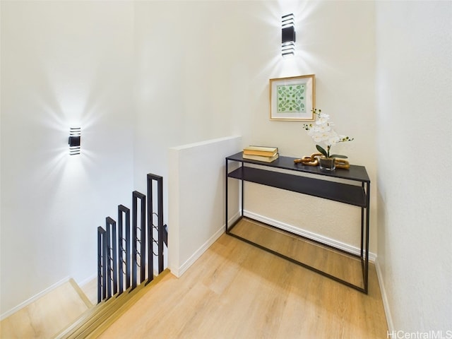 hall with light wood finished floors and baseboards