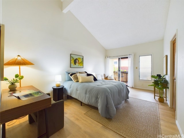 bedroom featuring access to exterior, baseboards, high vaulted ceiling, and light wood finished floors