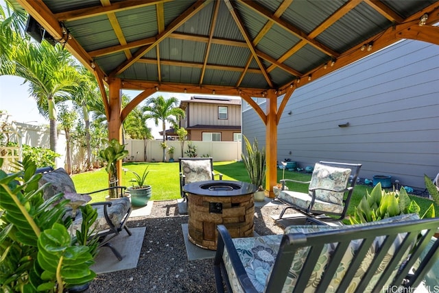 view of patio / terrace with a fire pit, a gazebo, and a fenced backyard