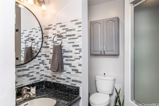 2121 Algaroba St Unit 1602, Honolulu, HI 96826 - bathroom with a shower with shower door, toilet, vanity, and decorative backsplash