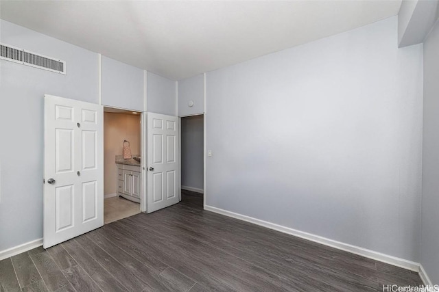 311 Ohua Ave Unit Ph D, Honolulu, HI 96815 - unfurnished bedroom featuring baseboards, visible vents, and dark wood-style flooring