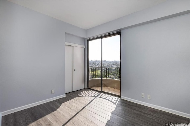 311 Ohua Ave Unit Ph D, Honolulu, HI 96815 - unfurnished bedroom featuring access to exterior, wood finished floors, and baseboards