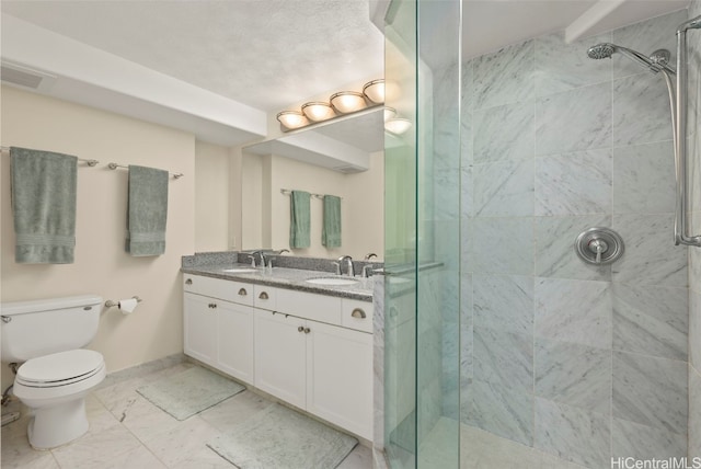 full bathroom with toilet, a stall shower, marble finish floor, and a sink