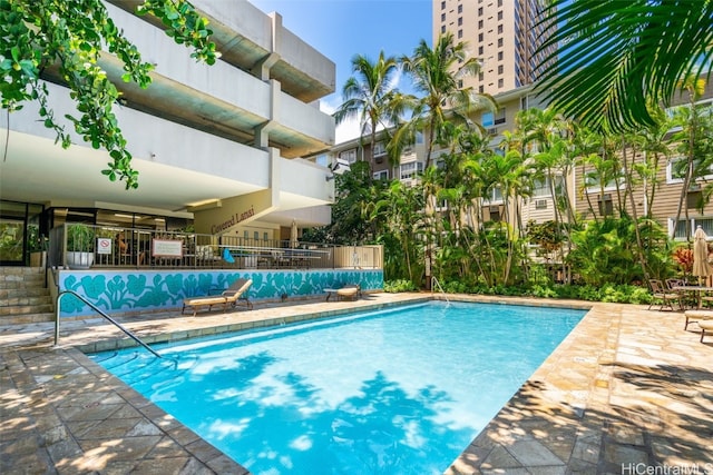 view of swimming pool with fence and a patio