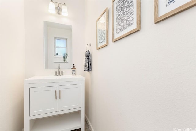 bathroom with vanity and baseboards