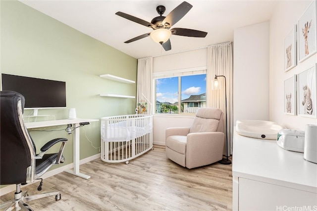 home office with ceiling fan, baseboards, and light wood-style floors