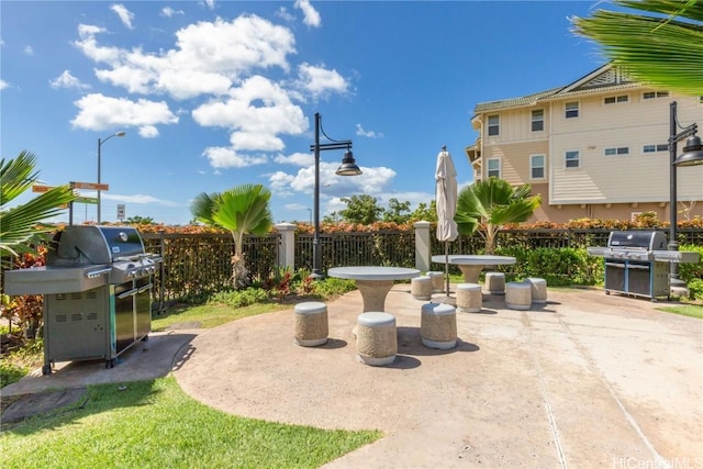 view of patio / terrace with a grill and fence