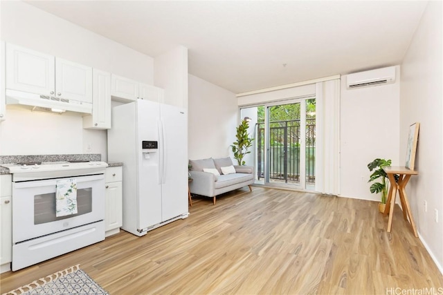 kitchen featuring light countertops, a wall mounted AC, white cabinets, white appliances, and under cabinet range hood