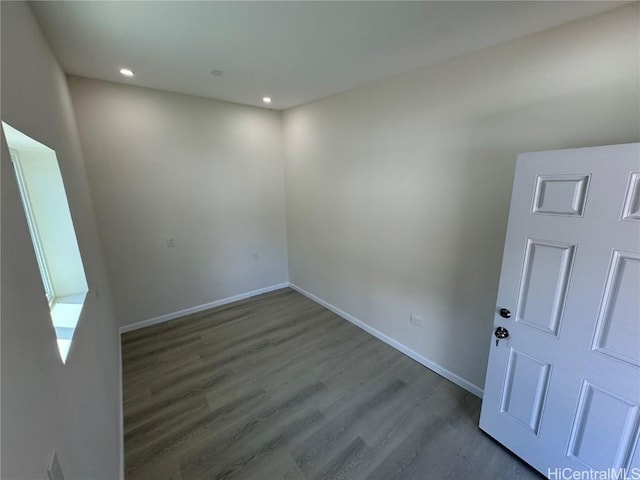 empty room featuring recessed lighting, baseboards, and wood finished floors