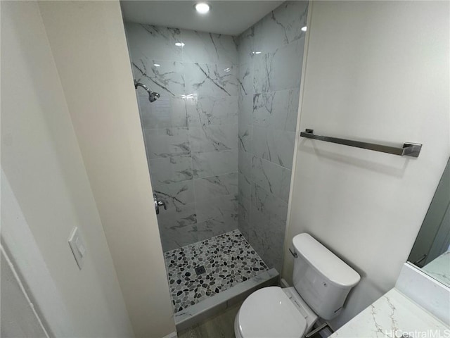 bathroom featuring a shower stall and toilet