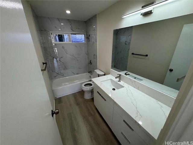 full bathroom with bathing tub / shower combination, recessed lighting, toilet, vanity, and wood finished floors