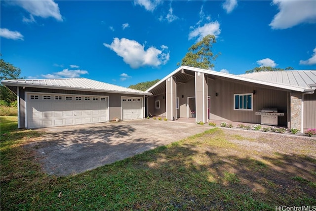 view of front of house featuring a garage and metal roof