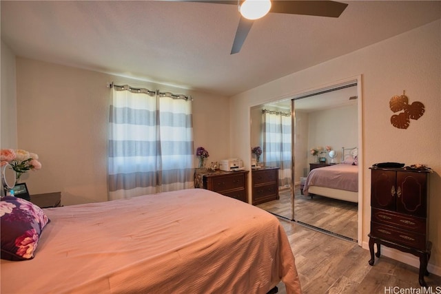 bedroom featuring a closet, a ceiling fan, and wood finished floors