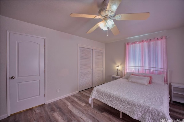 bedroom featuring a closet, ceiling fan, baseboards, and wood finished floors