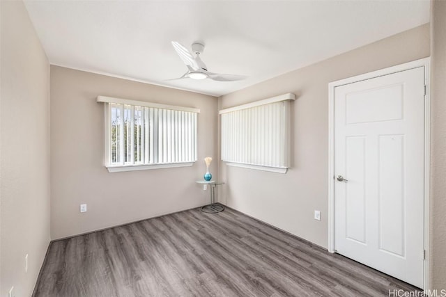 unfurnished room with a ceiling fan and wood finished floors