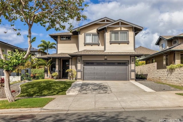 craftsman-style home featuring a front yard, concrete driveway, and an attached garage