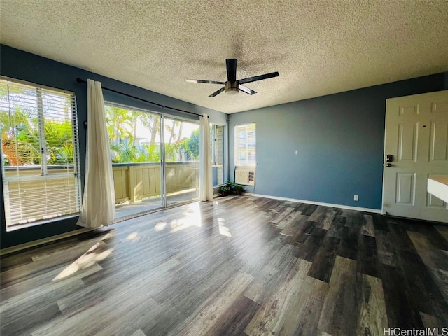 empty room with a healthy amount of sunlight, ceiling fan, baseboards, and wood finished floors