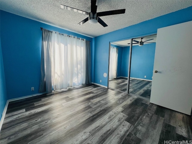 unfurnished bedroom featuring a textured ceiling, wood finished floors, a ceiling fan, and baseboards