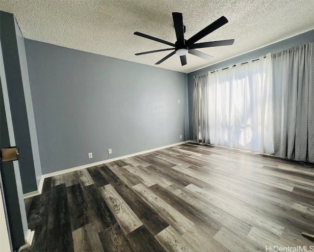 unfurnished room with a textured ceiling, wood finished floors, a ceiling fan, and baseboards