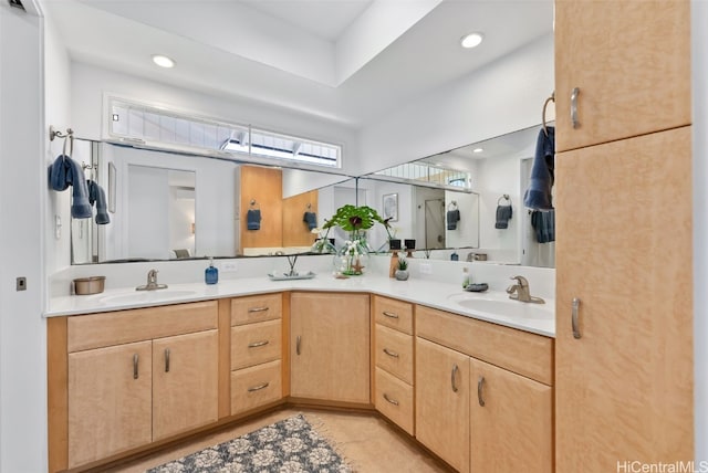 bathroom featuring recessed lighting, a sink, and double vanity