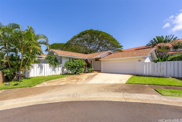 view of front of home with concrete driveway, fence, an attached garage, and stucco siding