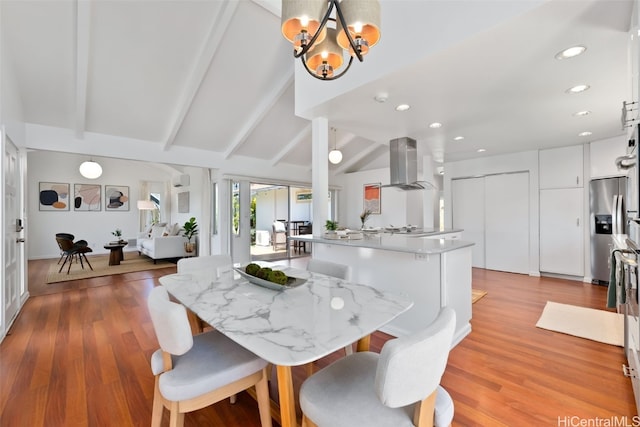 dining room featuring recessed lighting, lofted ceiling with beams, an inviting chandelier, and wood finished floors