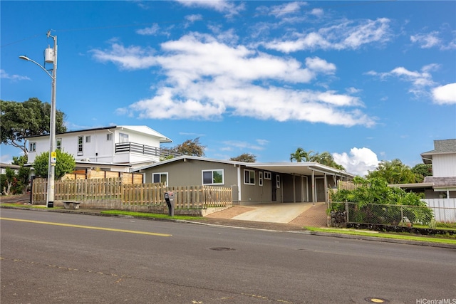 2445 Komo Mai Dr, Pearl City, HI 96782 - view of front of house with driveway, a carport, and a fenced front yard
