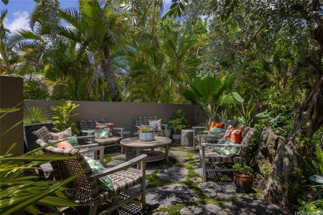 376 Dune Cir, Kailua, HI 96734 - fenced backyard with outdoor lounge area and a patio