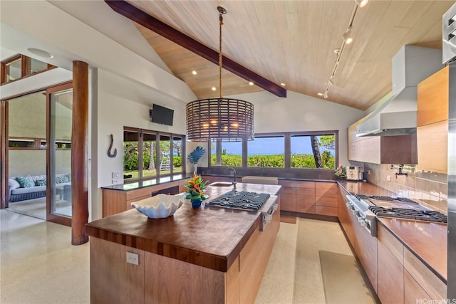 376 Dune Cir, Kailua, HI 96734 - kitchen featuring stainless steel gas cooktop, modern cabinets, an island with sink, high vaulted ceiling, and wall chimney range hood