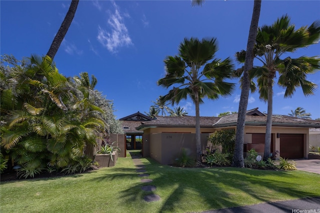 376 Dune Cir, Kailua, HI 96734 - view of yard with an attached garage and concrete driveway