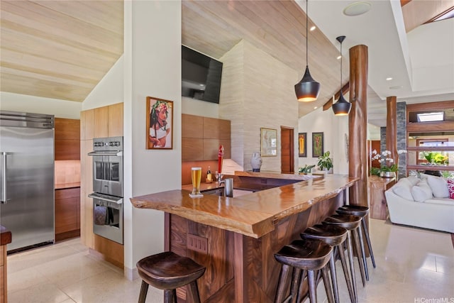 376 Dune Cir, Kailua, HI 96734 - kitchen with stainless steel appliances, modern cabinets, a kitchen breakfast bar, open floor plan, and high vaulted ceiling