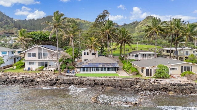 birds eye view of property with a water and mountain view