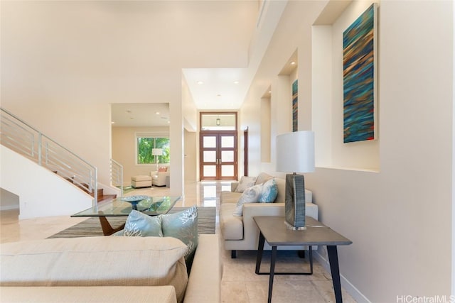 living room featuring tile patterned flooring, recessed lighting, baseboards, french doors, and stairway