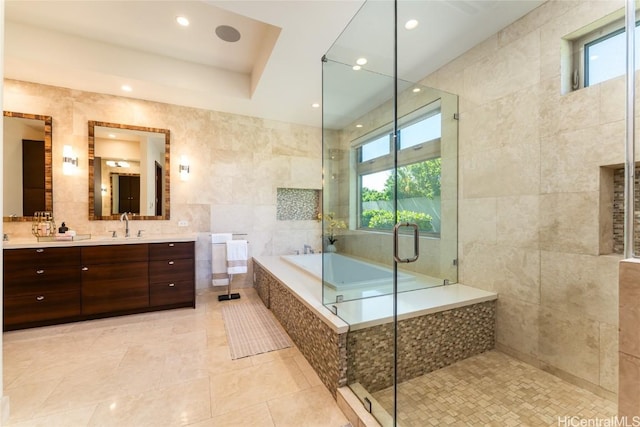 bathroom featuring a garden tub, tile walls, a shower stall, vanity, and tile patterned flooring