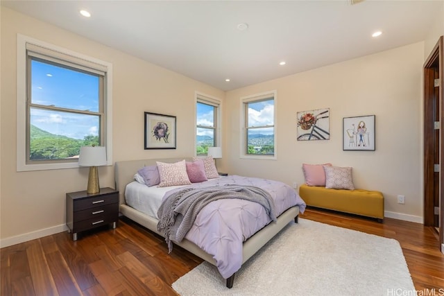 bedroom with dark wood-style floors, recessed lighting, and baseboards