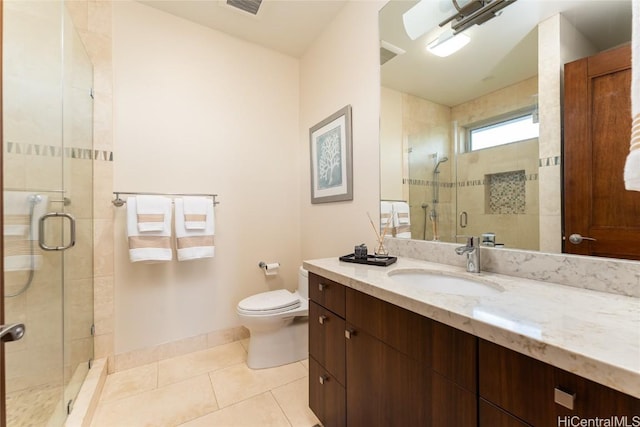 full bathroom featuring toilet, a shower stall, vanity, tile patterned flooring, and baseboards