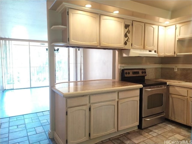 kitchen featuring stone finish floor, open shelves, under cabinet range hood, stainless steel electric stove, and light countertops