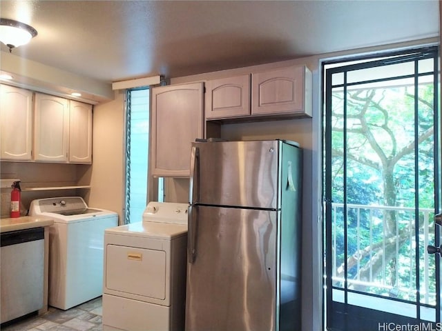 clothes washing area with washing machine and dryer and laundry area