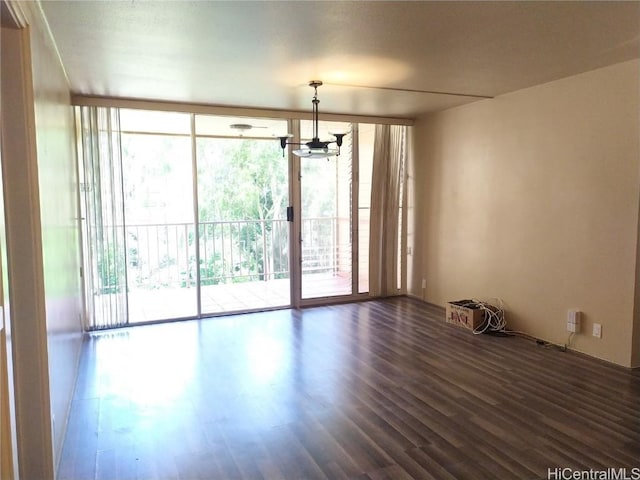 empty room with dark wood finished floors and floor to ceiling windows