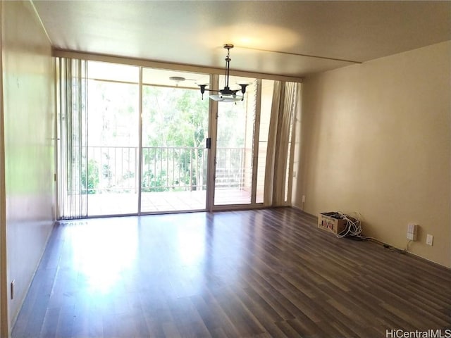 spare room with floor to ceiling windows and dark wood-style flooring