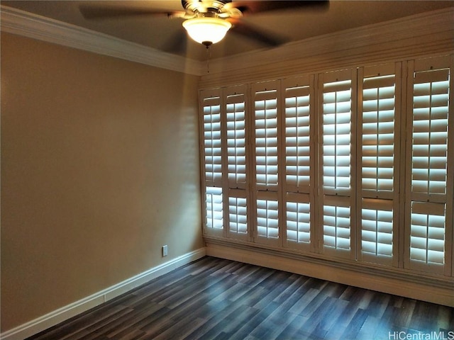 unfurnished room with dark wood-style flooring, ceiling fan, baseboards, and ornamental molding