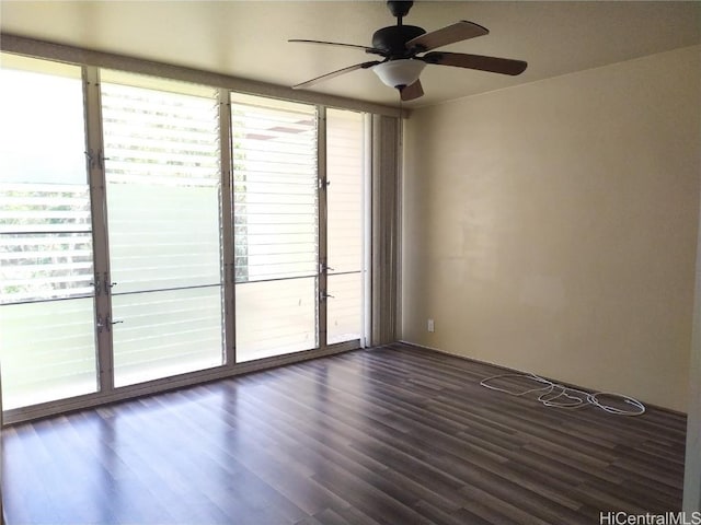 unfurnished room featuring ceiling fan and dark wood finished floors