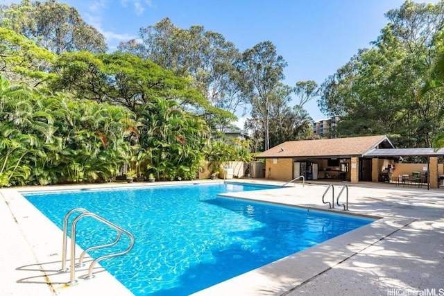 community pool featuring a patio and fence