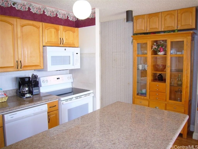 kitchen with white appliances and a textured ceiling