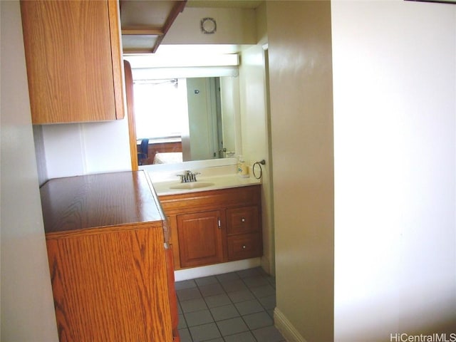 bathroom featuring tile patterned flooring and vanity