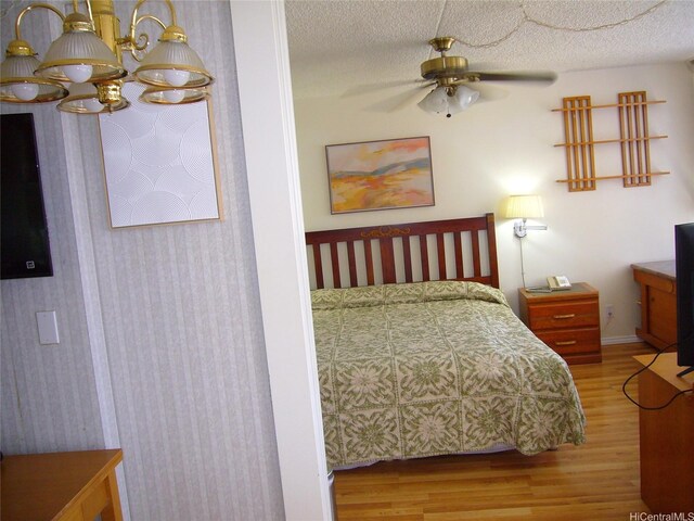201 Ohua Ave Unit 2112Mauka, Honolulu, HI 96815 - bedroom with wood finished floors, baseboards, and a textured ceiling