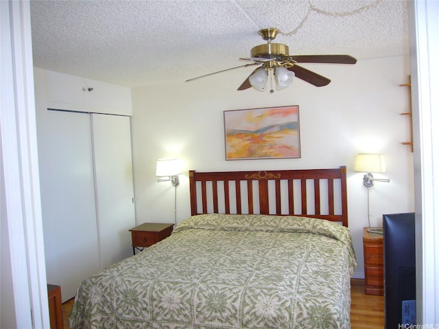 201 Ohua Ave Unit 2112Mauka, Honolulu, HI 96815 - bedroom with a textured ceiling, a closet, wood finished floors, and a ceiling fan