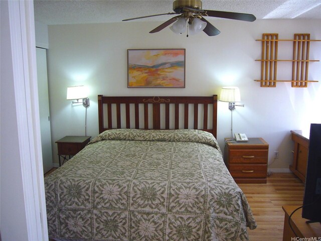 201 Ohua Ave Unit 2112Mauka, Honolulu, HI 96815 - bedroom with wood finished floors, baseboards, a ceiling fan, and a textured ceiling